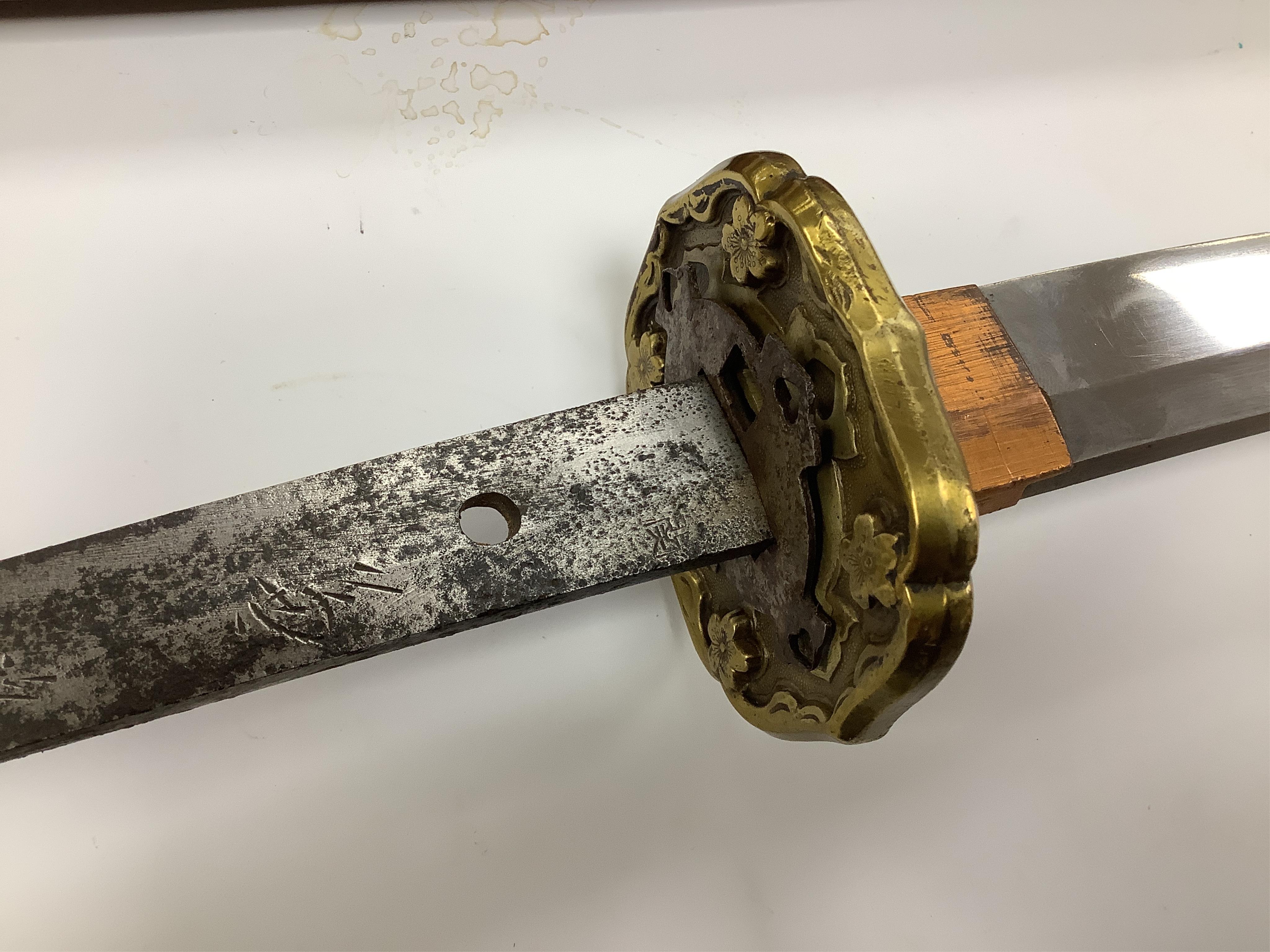 A Japanese WWII army officer’s sword Katana, blade 57.9cm, signed and dated with Seki Arsenal stamp, retaining good polish, in shin gunto mounts with leather combat cover on hilt and scabbard, the latter with plate stamp